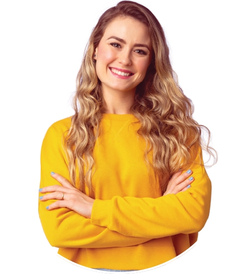 Smiling woman with long, wavy hair wearing a bright yellow sweater stands confidently with crossed arms. The tone is warm and approachable.