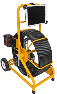 Yellow inspection camera system with a large coiled cable on a two-wheeled frame. A tablet is mounted on top and a battery pack is attached to the side.