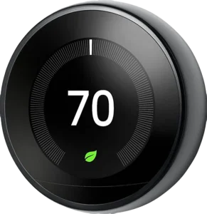 Smart thermostat displaying 70 degrees on a circular, sleek black interface, with a green leaf icon below, symbolizing energy efficiency.